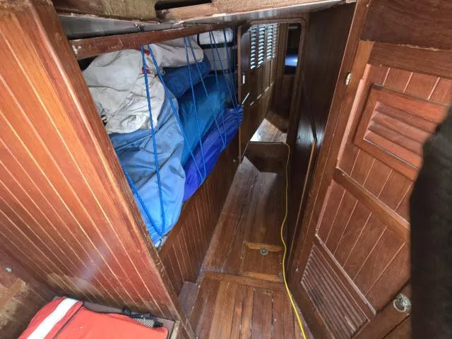 Slide: The Image of 1978 Formosa 46 yacht interior with wooden paneling and bunk beds. - 10