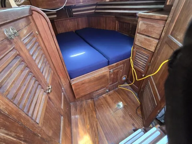 Slide: The Image of 1978 Formosa 46 yacht interior with wooden cabin and blue cushions. - 11