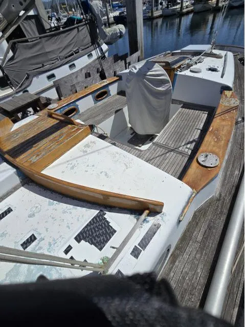 Slide: The Image of 1978 Formosa 46 sailboat deck with wooden accents, docked at a marina. - 13