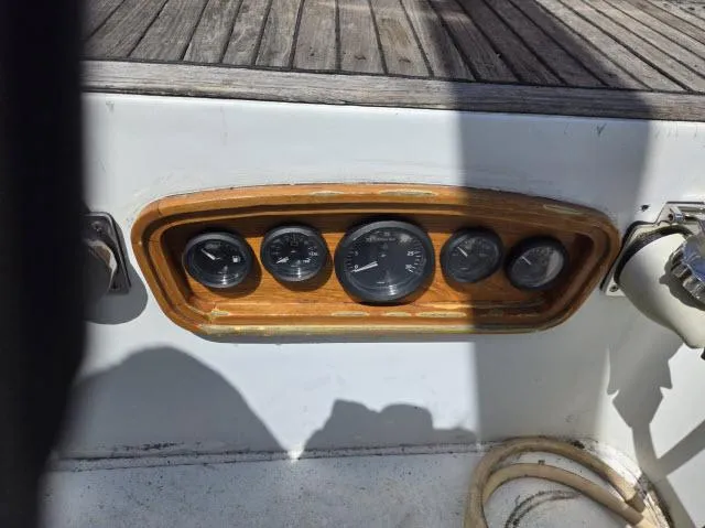 Slide: The Image of Instrument panel on a 1978 Formosa 46 sailboat, featuring wooden trim and multiple gauges. - 17