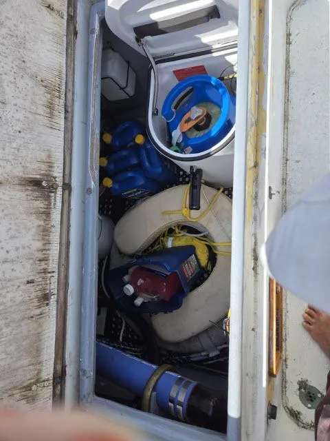 Slide: The Image of Storage compartment on a 1978 Formosa 46 boat, filled with life jackets and equipment. - 19
