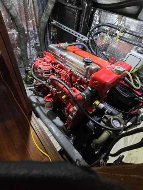 Slide: The Image of 1978 Formosa 46 engine room with red engine and wiring. - 26