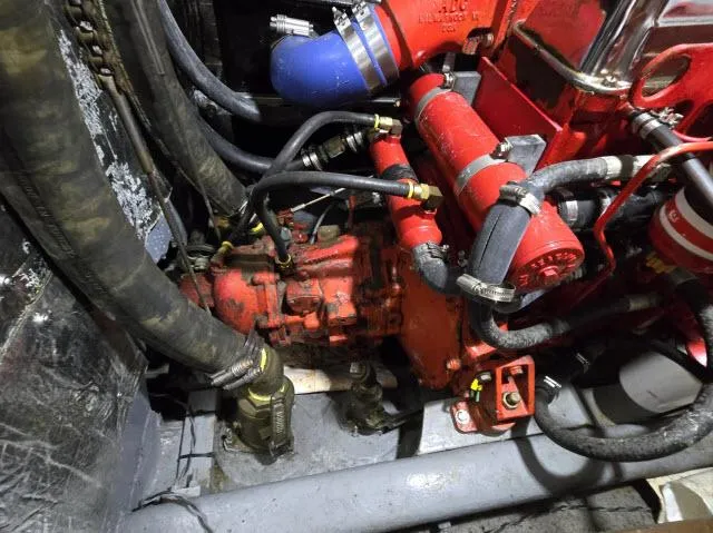 Slide: The Image of Engine compartment of a 1978 Formosa 46 sailboat, featuring red and blue components. - 27