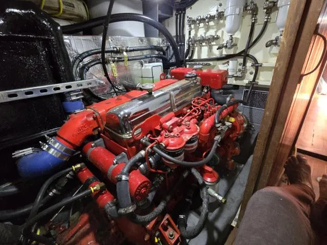 Slide: The Image of Engine room of a 1978 Formosa 46 yacht, featuring a red engine with visible wiring and components. - 28