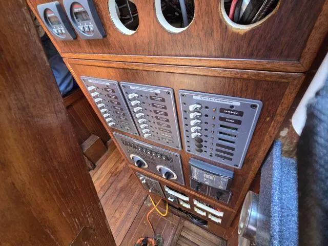 Slide: The Image of Electrical control panel on a 1978 Formosa 46 sailboat, featuring switches and gauges. - 30