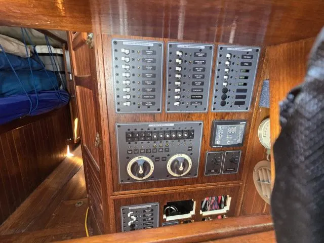 Slide: The Image of Electrical control panel on a 1978 Formosa 46 sailboat, featuring switches and gauges. - 31