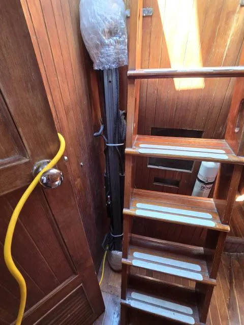 Slide: The Image of Wooden interior of 1978 Formosa 46 sailboat with stairs and storage area. - 33