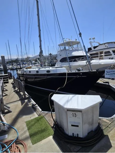 Slide: The Image of 1978 Formosa 46 sailboat docked at marina, surrounded by other boats under clear blue sky. - 34
