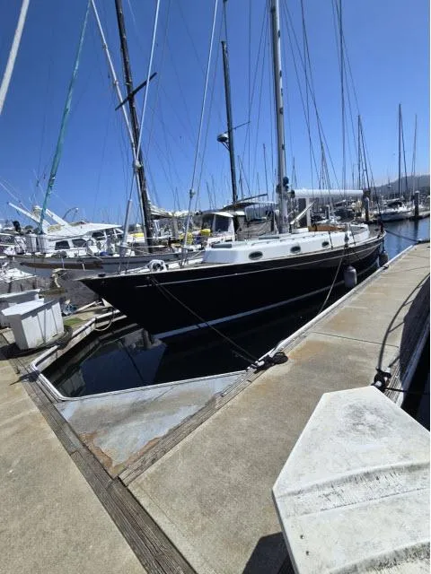 Slide: The Image of 1978 Formosa 46 sailboat docked at marina under clear blue sky. - 35