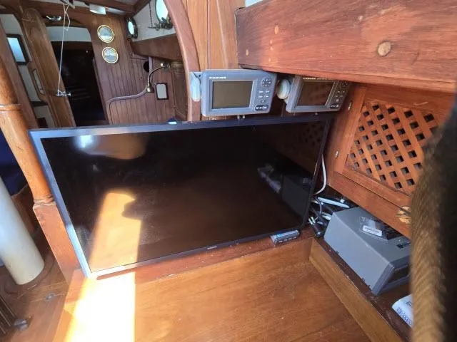 Slide: The Image of 1978 Formosa 46 yacht interior with navigation equipment and wooden paneling. - 6