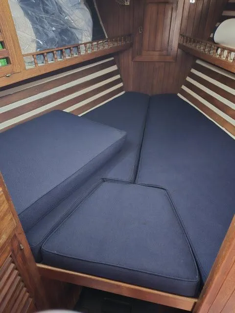 Slide: The Image of Interior cabin of a 1978 Formosa 46 sailboat with blue cushions. - 8