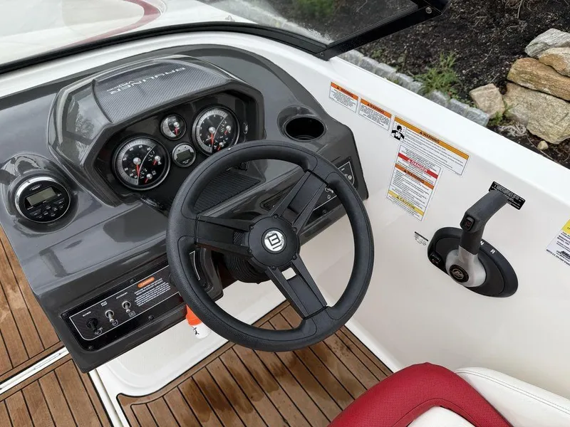 Slide: The Image of 2016 Bayliner VR5 Bowrider dashboard with steering wheel and control panel. - 13