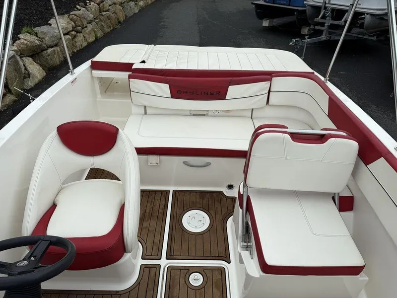 Slide: The Image of 2016 Bayliner VR5 Bowrider interior with red and white seating, wooden flooring. - 15