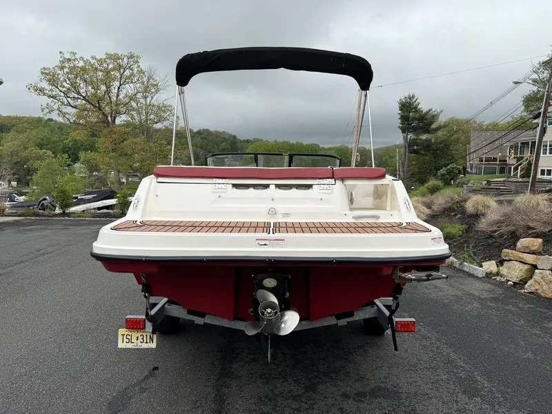 Slide: The Image of 2016 Bayliner VR5 Bowrider boat, rear view, parked on a road with scenic background. - 4