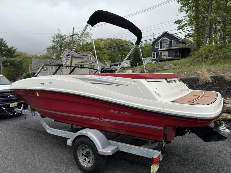 Slide: The Image of 2016 Bayliner VR5 Bowrider boat on trailer, red and white design, parked outdoors. - 5