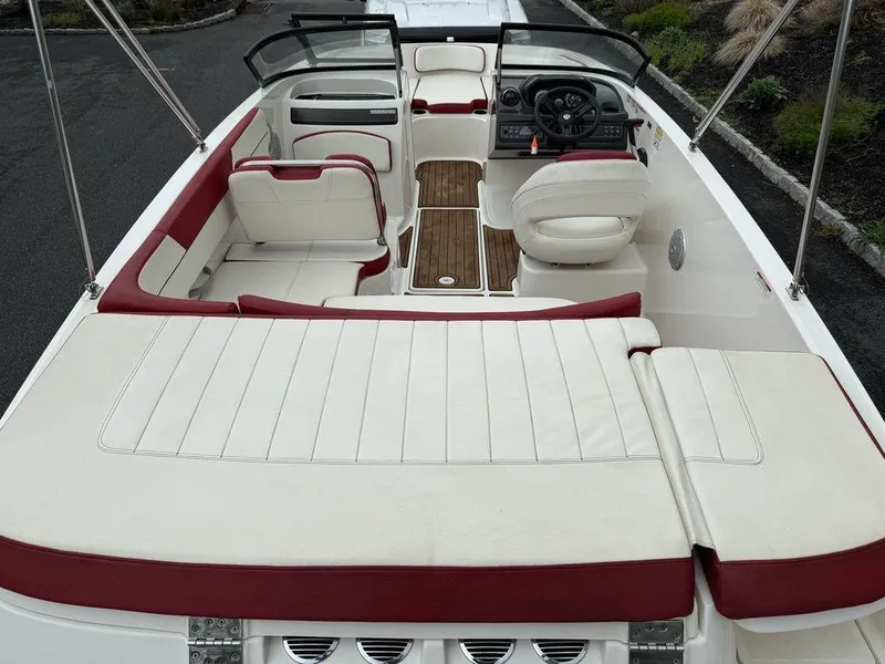 Slide: The Image of 2016 Bayliner VR5 Bowrider interior with white and red seating, wood accents, and steering console. - 9