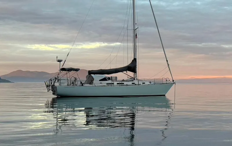 The Image of 1998 J Boats J 42 sailboat on calm water at sunset. - 0