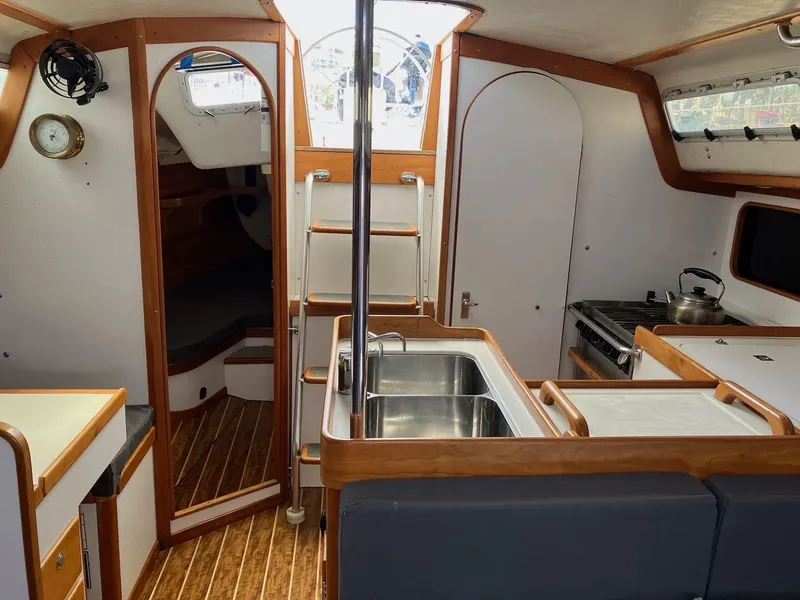 Slide: The Image of Interior of 1998 J Boats J 42 sailboat with kitchen and seating area. - 10