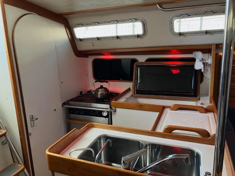 Slide: The Image of Interior of 1998 J Boats J 42 sailboat kitchen with stove, sink, and microwave. - 11