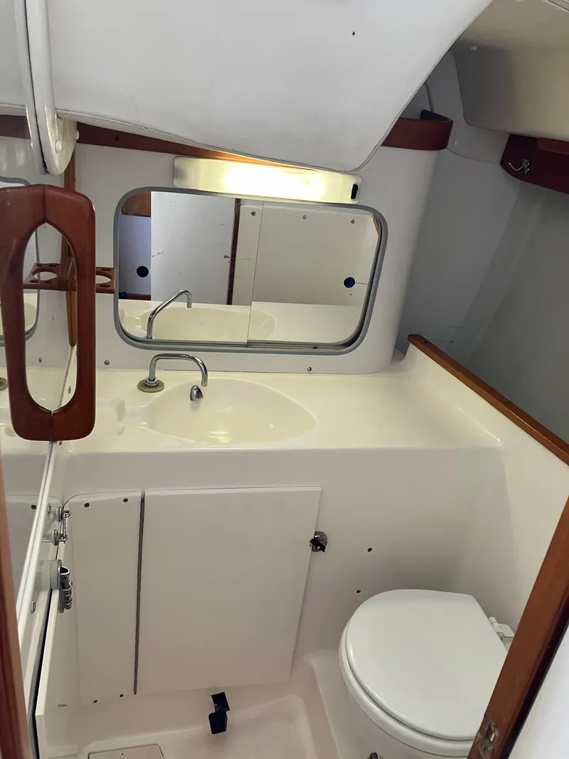 Slide: The Image of 1998 J Boats J 42 yacht bathroom with sink, mirror, and toilet. - 14
