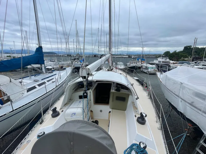 Slide: The Image of 1998 J Boats J 42 sailboat docked in a marina, surrounded by other vessels. - 17
