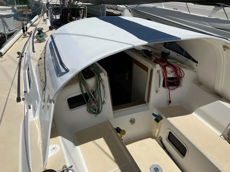 Slide: The Image of 1998 J Boats J 42 sailboat cockpit with ropes and open cabin entrance. - 4