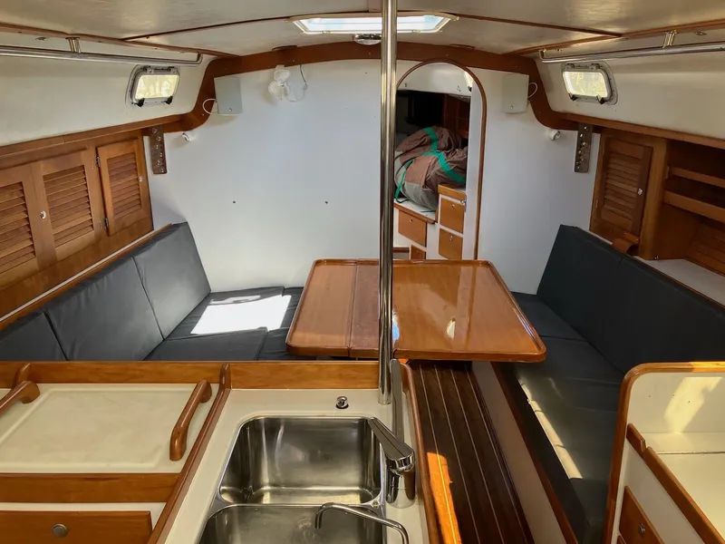 Slide: The Image of Interior of 1998 J Boats J 42 sailboat with wood accents and seating area. - 9