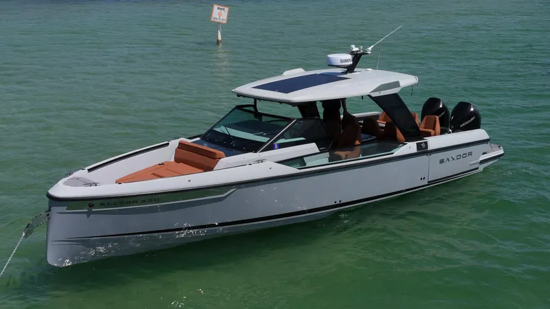 Slide: The Image of 2023 Saxdor 320 GTO boat cruising on calm green water. - 0