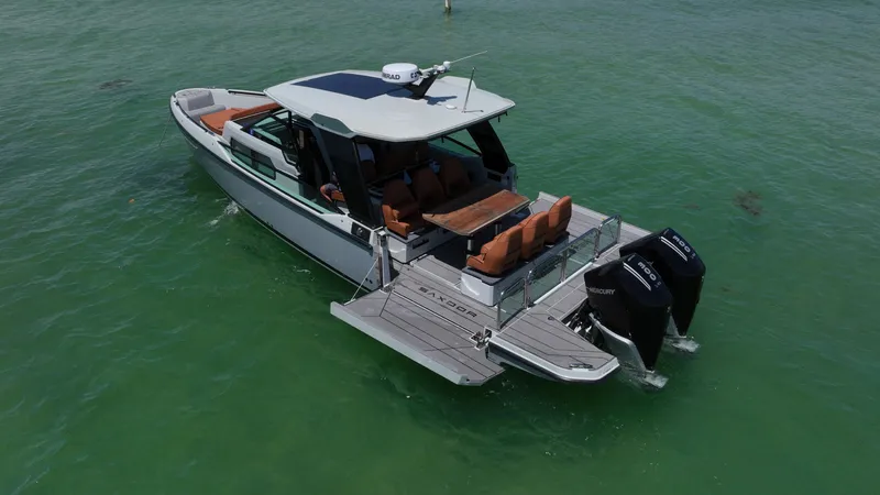 Slide: The Image of 2023 Saxdor 320 GTO boat on clear water, featuring dual outboard engines. - 10