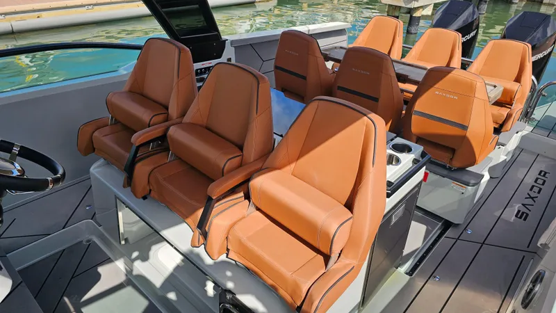 Slide: The Image of 2023 Saxdor 320 GTO boat interior with luxurious tan leather seating. - 13