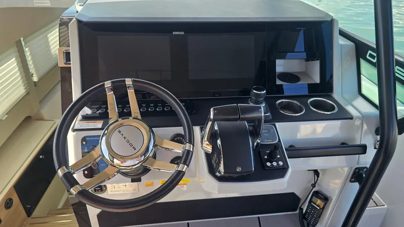 Slide: The Image of Steering console of 2023 Saxdor 320 GTO boat with modern controls and displays. - 15
