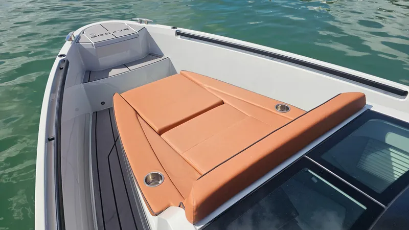 Slide: The Image of 2023 Saxdor 320 GTO boat with tan seating, on calm water. - 17
