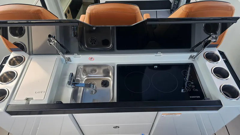 Slide: The Image of Modern kitchen area on 2023 Saxdor 320 GTO boat with sink, stove, and storage. - 24