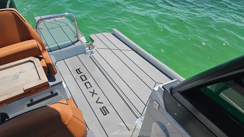 Slide: The Image of 2023 Saxdor 320 GTO boat deck with seating, on clear green water. - 28