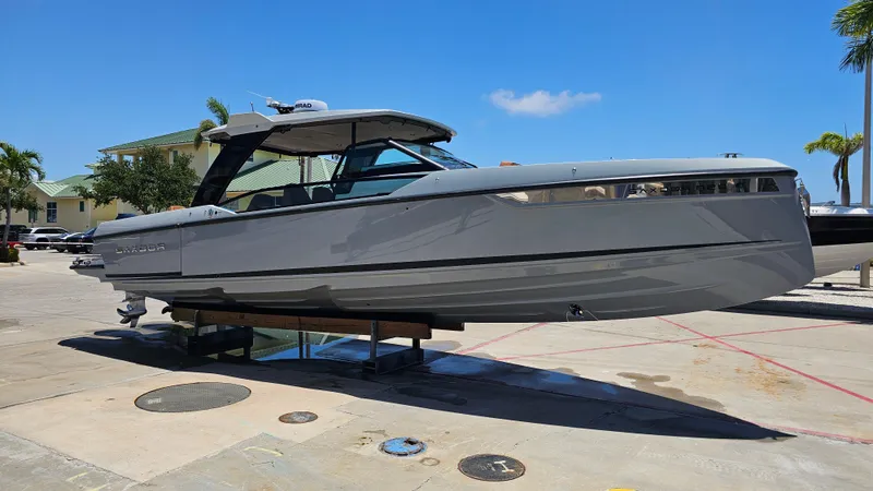 Slide: The Image of 2023 Saxdor 320 GTO boat on display, sleek design, sunny day, palm trees in background. - 34