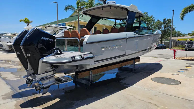 Slide: The Image of 2023 Saxdor 320 GTO boat with Mercury engine, displayed outdoors on a sunny day. - 38