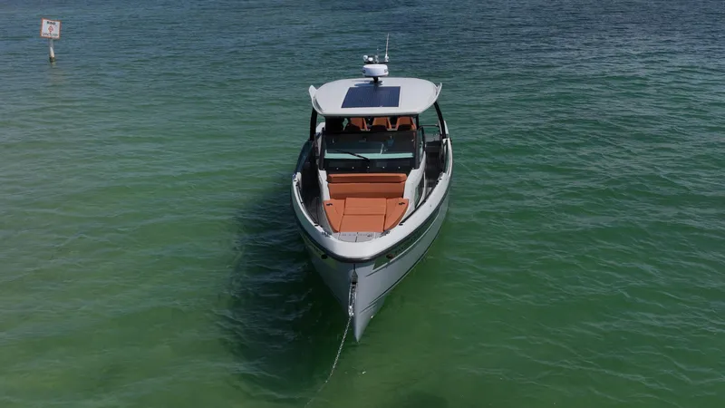 Slide: The Image of 2023 Saxdor 320 GTO boat on calm green water, front view. - 7