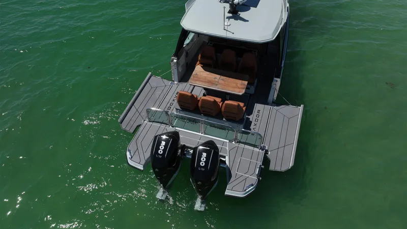 Slide: The Image of 2023 Saxdor 320 GTO boat with dual engines on green water. - 8