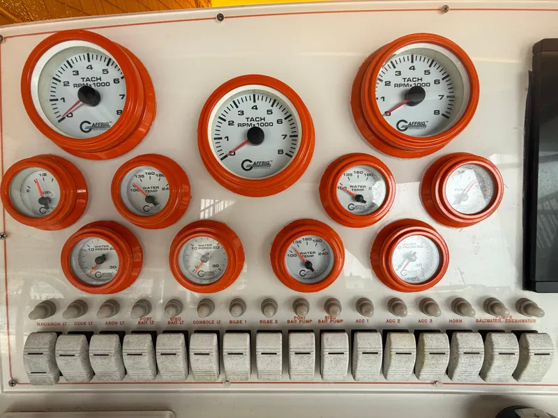 Slide: The Image of Dashboard of a 2007 Carrera Boats 36 Center Console with gauges and switches. - 10