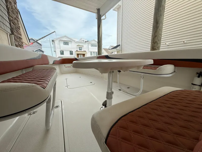 Slide: The Image of 2007 Carrera Boats 36 Center Console interior with cushioned seating and table. - 13