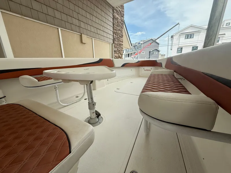 Slide: The Image of 2007 Carrera Boats 36 Center Console interior with cushioned seating and table. - 15
