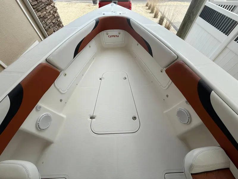 Slide: The Image of 2007 Carrera Boats 36 Center Console interior with white and brown seating. - 18