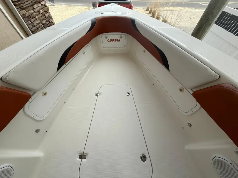 Slide: The Image of 2007 Carrera Boats 36 Center Console interior with white and brown seating. - 19