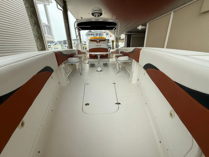 Slide: The Image of 2007 Carrera Boats 36 Center Console interior with white and brown seating, docked in marina. - 20
