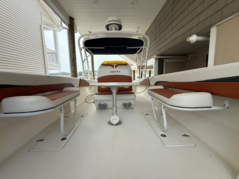 Slide: The Image of 2007 Carrera Boats 36 Center Console with seating and Garmin equipment under a covered dock. - 23