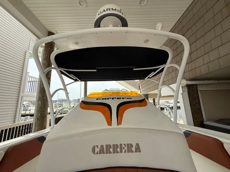 Slide: The Image of 2007 Carrera Boats 36 Center Console with Garmin equipment, docked under a covered area. - 25