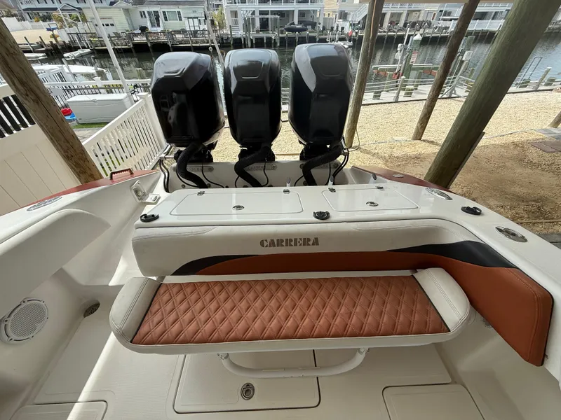 Slide: The Image of 2007 Carrera Boats 36 Center Console with triple engines and cushioned seating, docked by waterfront. - 27