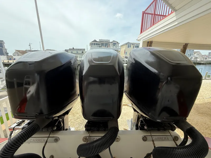 Slide: The Image of Triple outboard motors on a 2007 Carrera Boats 36 Center Console. - 28