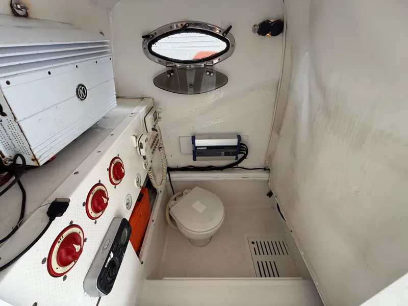 Slide: The Image of 2007 Carrera Boats 36 Center Console interior with control panel and marine toilet. - 34