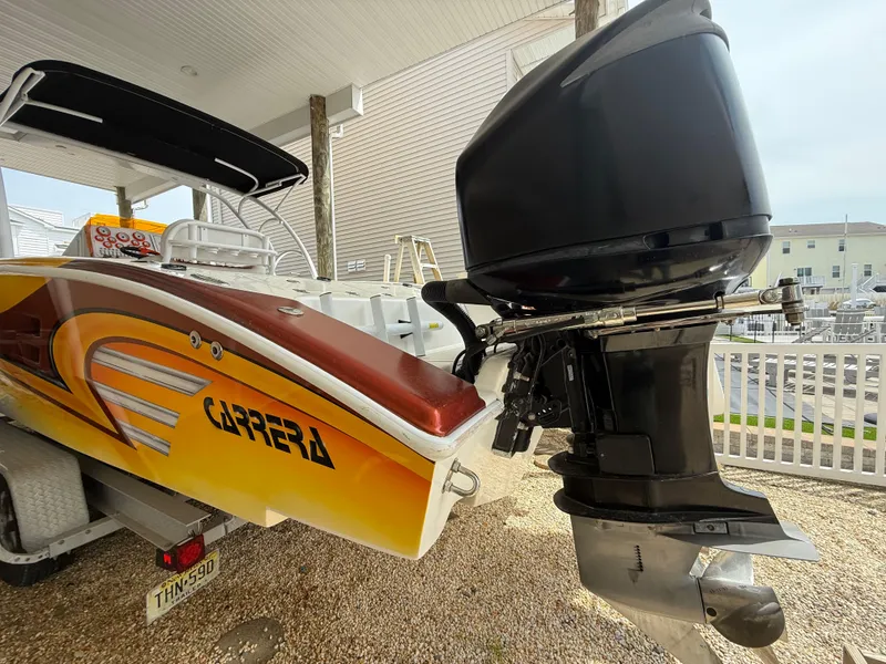 Slide: The Image of 2007 Carrera Boats 36 Center Console with vibrant graphics and powerful outboard motor. - 40